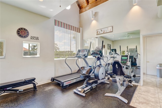 gym featuring ceiling fan and a towering ceiling