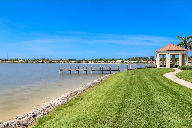 view of dock featuring a lawn, a gazebo, and a water view