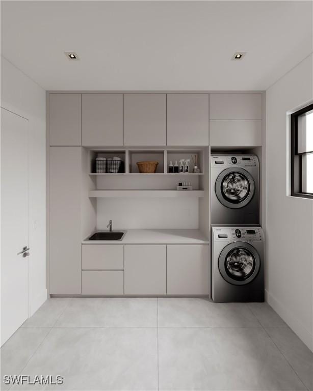 laundry area featuring stacked washer and dryer, cabinets, and sink