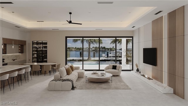 living room featuring a tray ceiling and ceiling fan