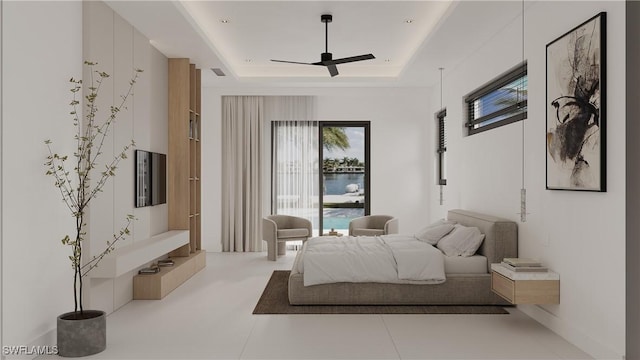 bedroom featuring a raised ceiling and ceiling fan