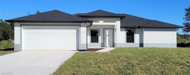 view of front facade with a garage and a front lawn