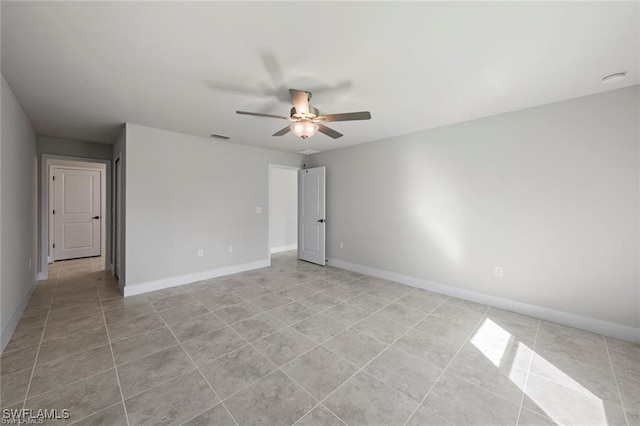 spare room featuring ceiling fan and light tile patterned floors