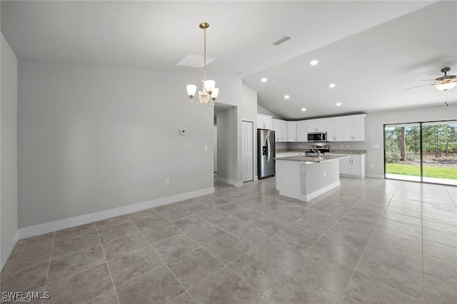 kitchen with white cabinetry, stainless steel appliances, decorative light fixtures, a center island with sink, and ceiling fan with notable chandelier