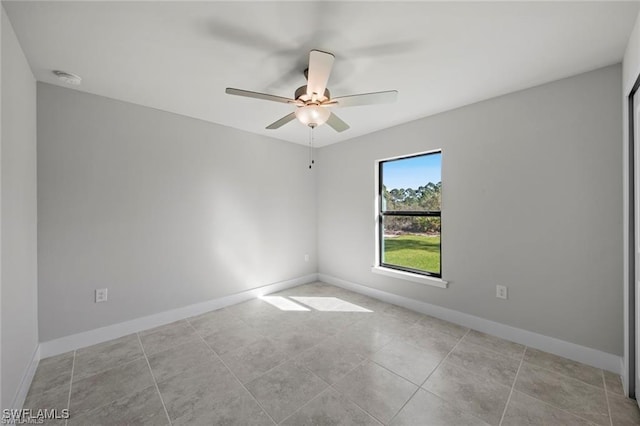 unfurnished room with ceiling fan and light tile patterned flooring