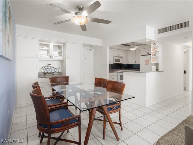 dining area featuring ceiling fan and light tile patterned floors