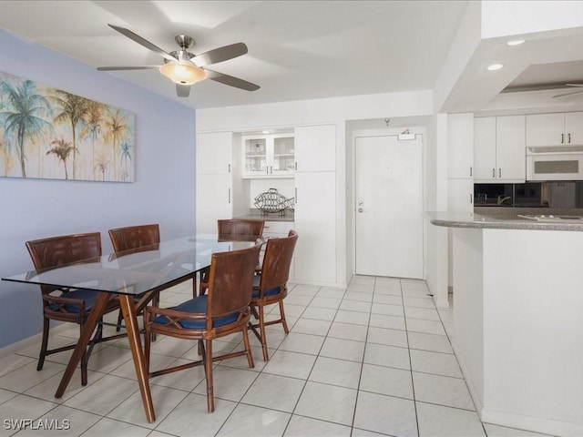 dining area featuring light tile patterned floors and ceiling fan