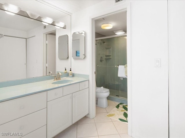 bathroom featuring tile patterned floors, vanity, an enclosed shower, and toilet