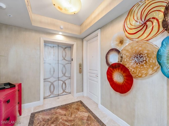 foyer with a tray ceiling