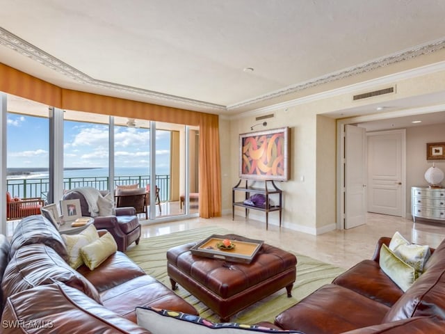 living room featuring a water view and crown molding