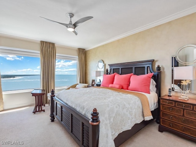 bedroom featuring light carpet, a water view, ceiling fan, and crown molding