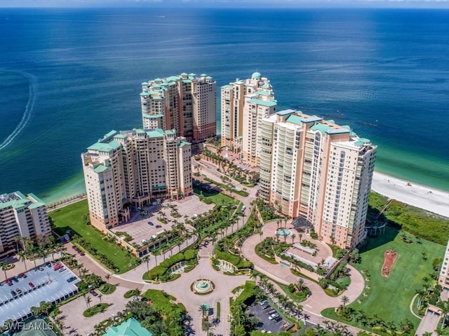 birds eye view of property featuring a beach view and a water view