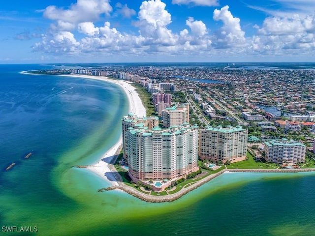 drone / aerial view featuring a water view and a beach view