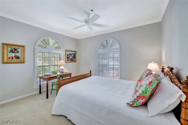 carpeted bedroom with ceiling fan and ornamental molding