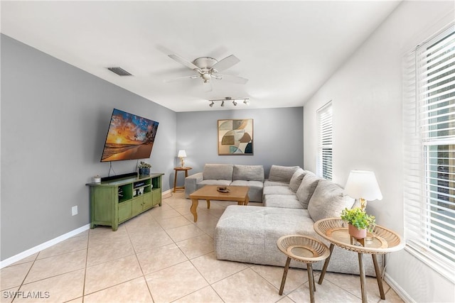 tiled living room featuring ceiling fan and track lighting