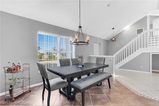 tiled dining space with lofted ceiling and an inviting chandelier