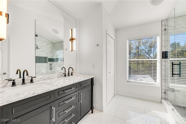 bathroom featuring tile patterned flooring, walk in shower, and vanity