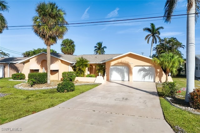 ranch-style home with a garage and a front lawn