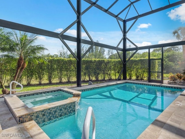 view of pool with glass enclosure and an in ground hot tub