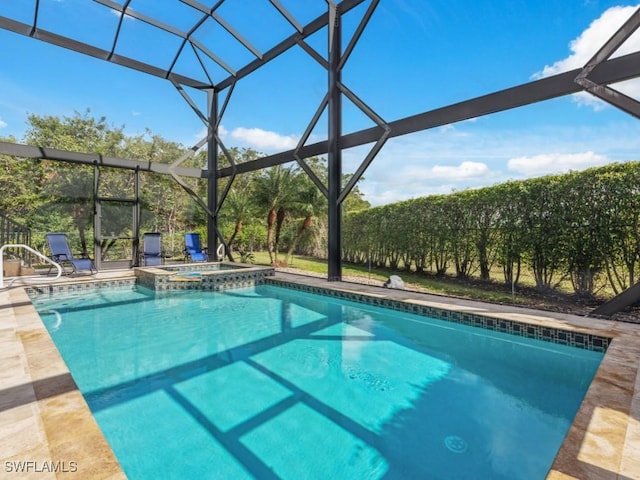 view of swimming pool with a lanai, a patio area, and an in ground hot tub