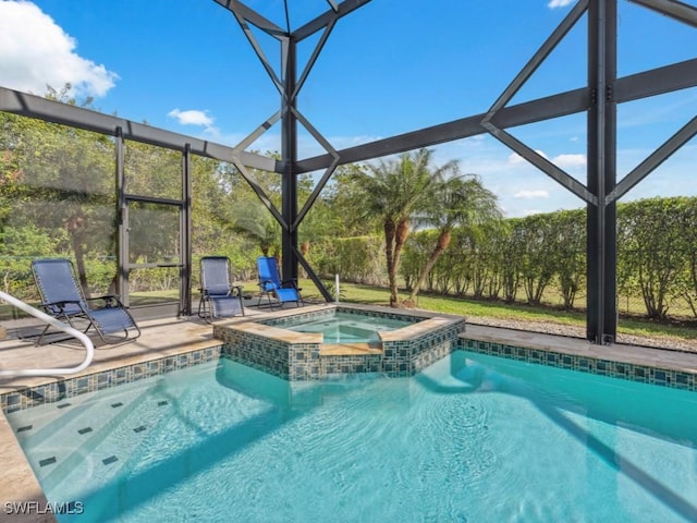 view of swimming pool with an in ground hot tub, glass enclosure, and a patio area