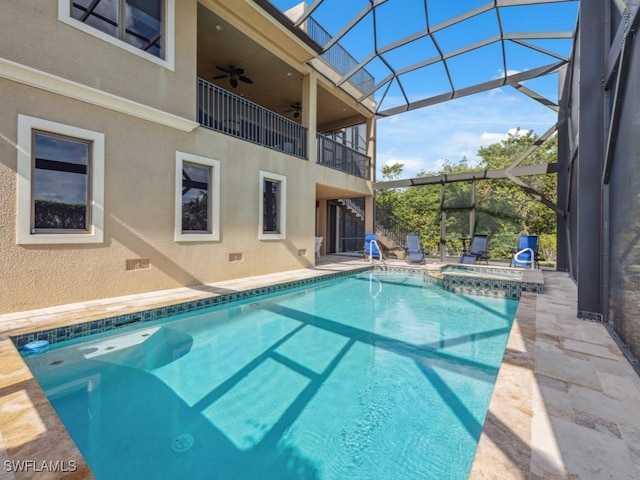 view of swimming pool featuring a lanai, a patio area, and ceiling fan