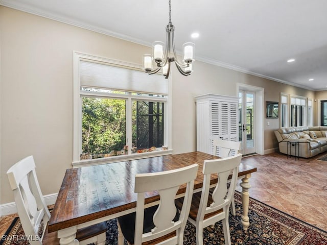 dining space featuring a healthy amount of sunlight, crown molding, and a chandelier