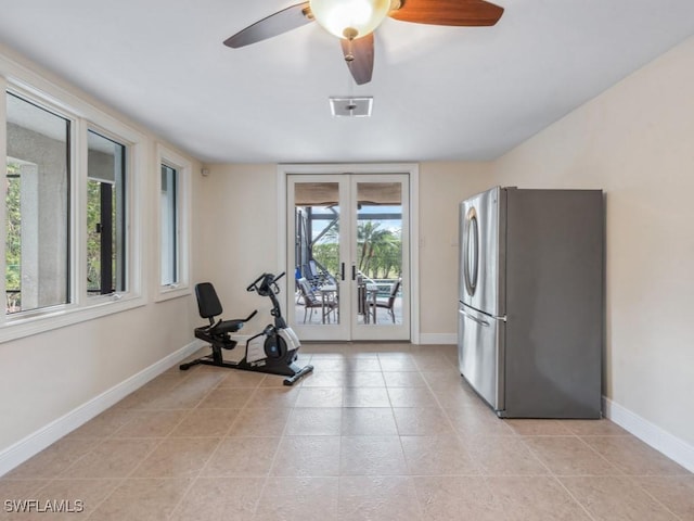 workout room featuring ceiling fan, french doors, light tile patterned floors, and a healthy amount of sunlight