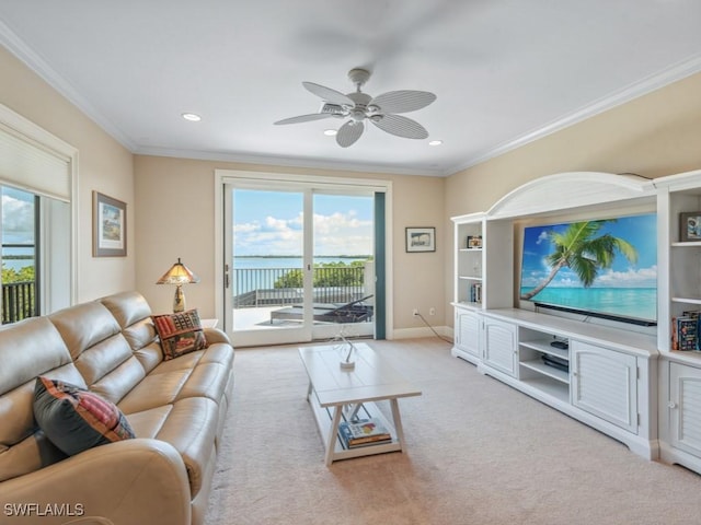 carpeted living room featuring ceiling fan and crown molding