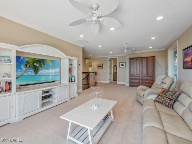 carpeted living room featuring crown molding and ceiling fan