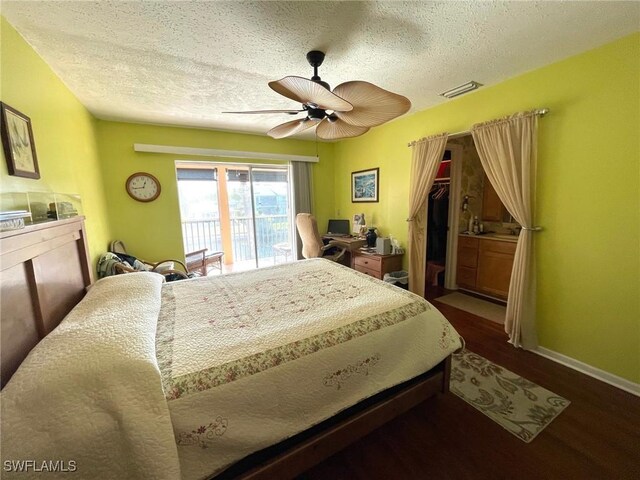 bedroom featuring dark wood-type flooring, a textured ceiling, access to exterior, and ceiling fan