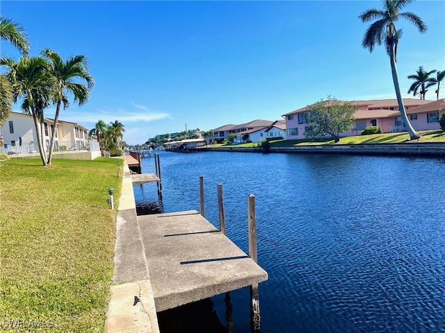 view of dock featuring a yard and a water view