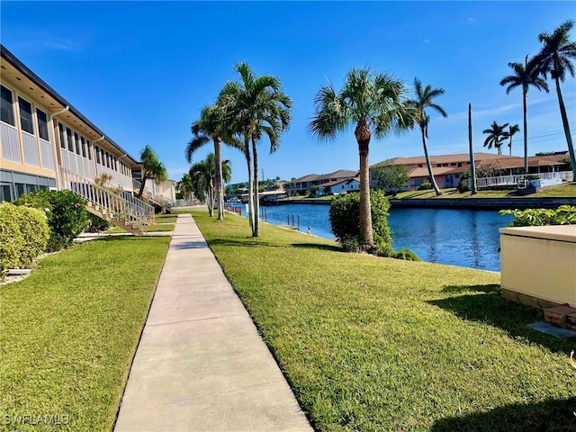 view of home's community featuring a water view and a lawn