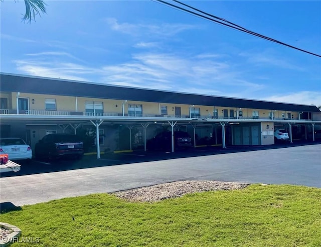 view of building exterior with covered parking