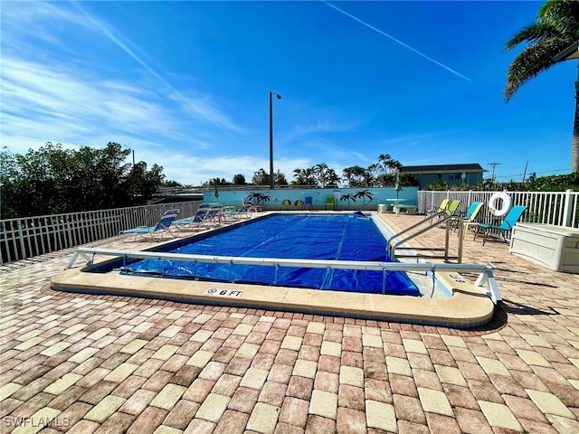 view of pool featuring a patio