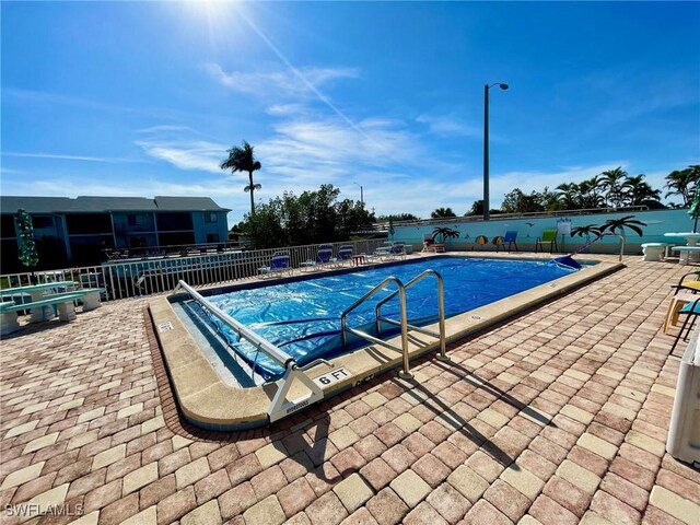 view of swimming pool with a patio area