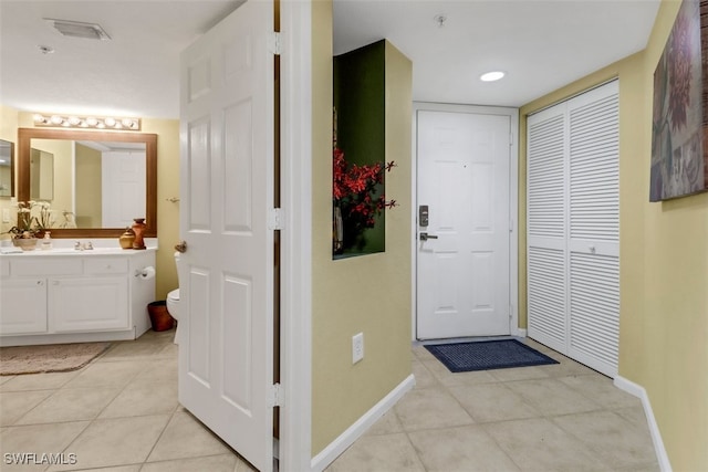 interior space featuring light tile patterned floors and sink