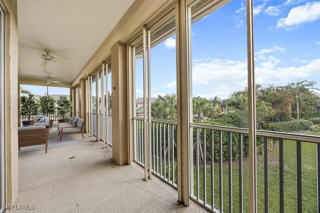 unfurnished sunroom with ceiling fan