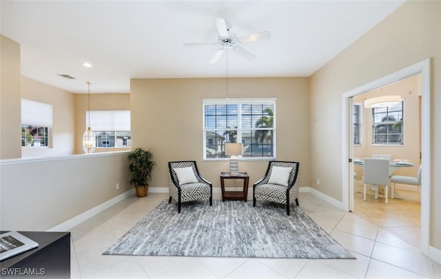 sitting room with light tile patterned floors and ceiling fan