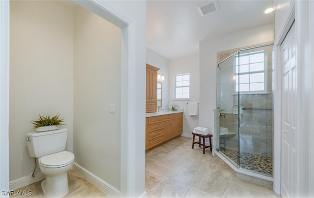 bathroom featuring walk in shower, vanity, and toilet