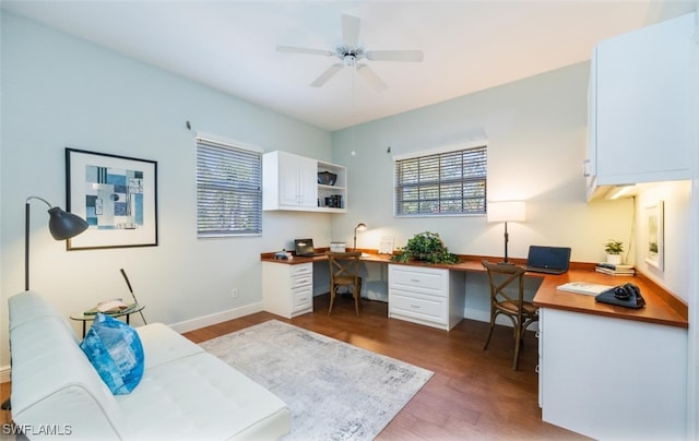 office area with dark hardwood / wood-style floors, built in desk, and ceiling fan