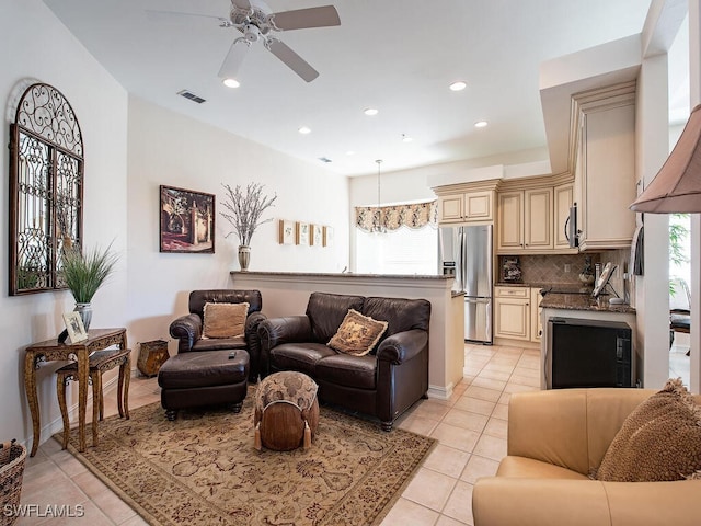 tiled living room with ceiling fan