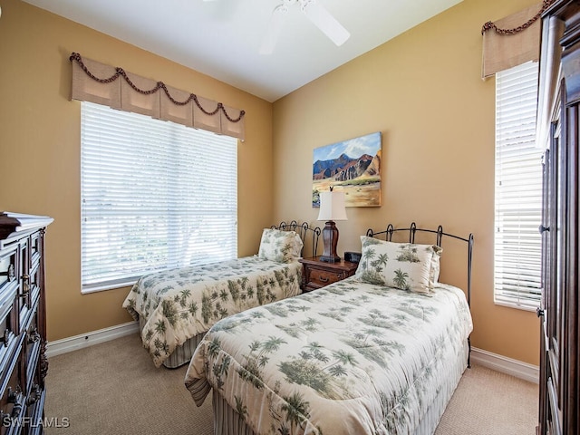 bedroom with ceiling fan and light carpet