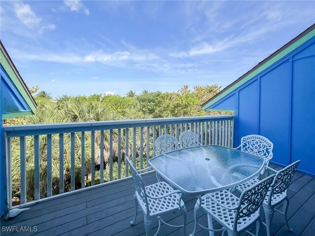 564 Coral Cir, Captiva, FL 33924 - wooden deck with outdoor dining space