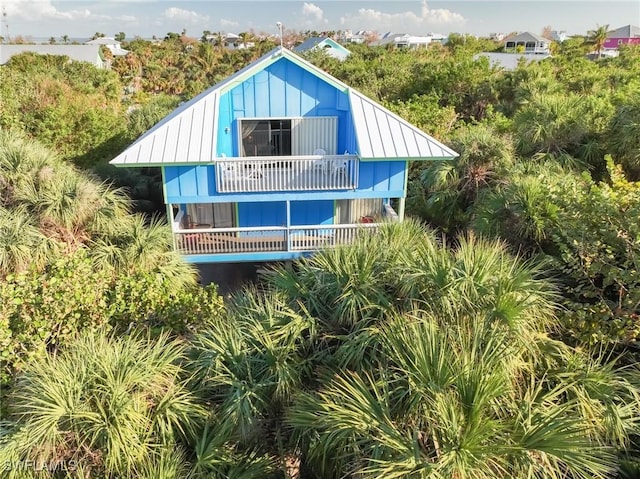 564 Coral Cir, Captiva, FL 33924 - view of front of property featuring a balcony and a metal roof