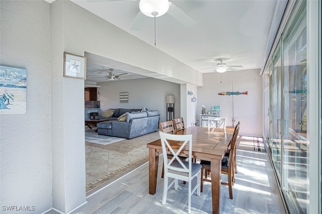 dining room with ceiling fan and light wood-type flooring