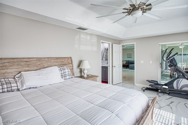 bedroom featuring ensuite bathroom, a tray ceiling, ceiling fan, a spacious closet, and a closet