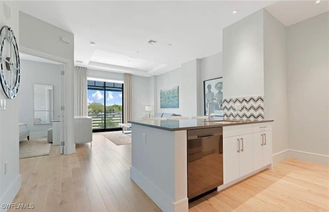 kitchen featuring kitchen peninsula, white cabinets, sink, light hardwood / wood-style flooring, and dishwasher