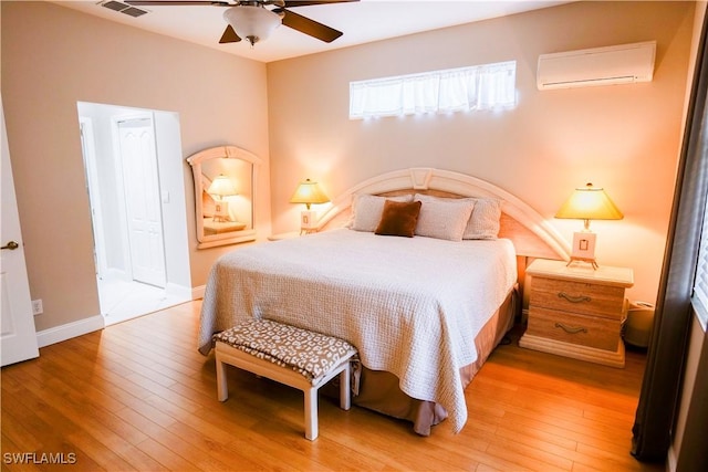 bedroom featuring a wall mounted AC, ceiling fan, and hardwood / wood-style floors