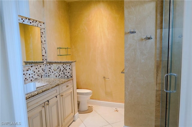 bathroom with backsplash, tile patterned floors, walk in shower, vanity, and toilet